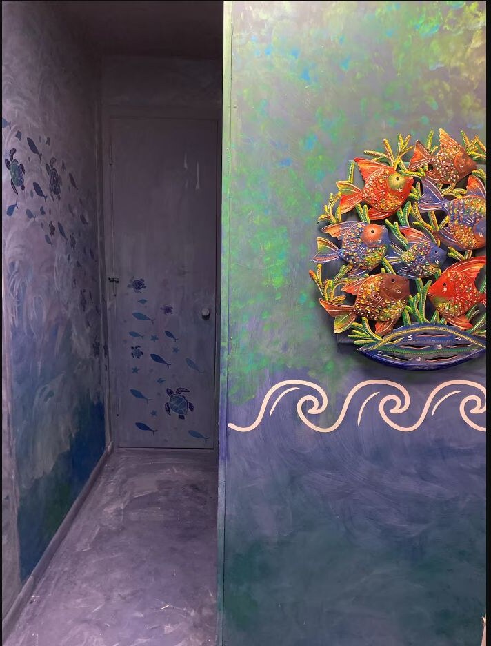 Ocean themed bathroom passage with fish and turtle details