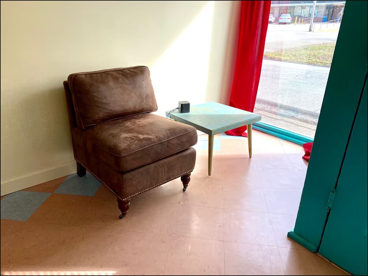 Sunny sitting area near the teal front door