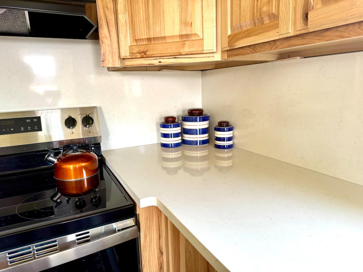 Kitchen range, hickory cabinets and quartz counter