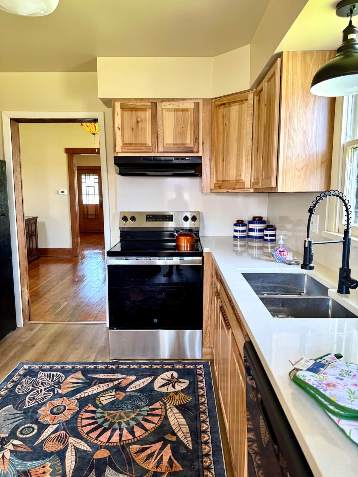 Kitchen work area with sink, range and hickory cabinets