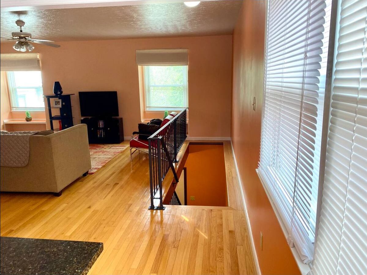 Open landing connecting the kitchen, living room, and staircase