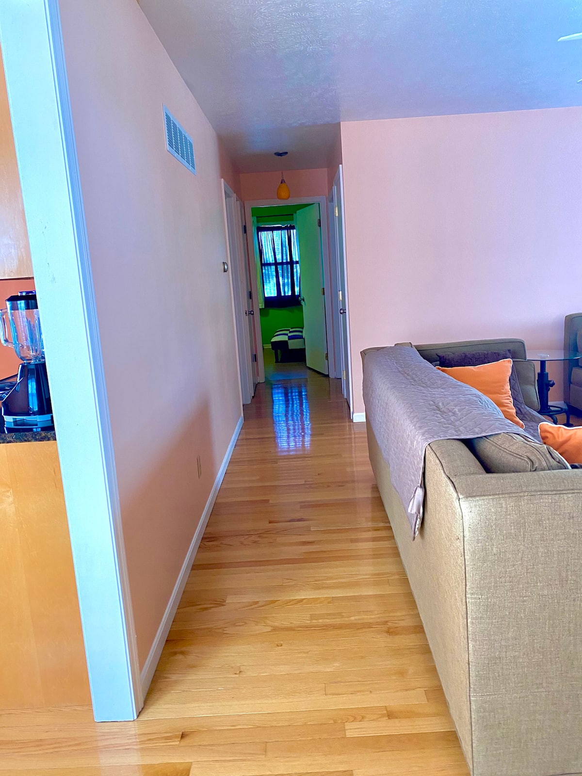 Hardwood hallway connecting the apartment rooms
