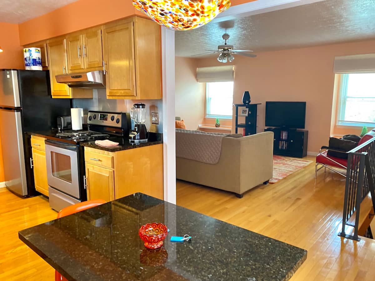 Modern kitchen opening into the bright living room