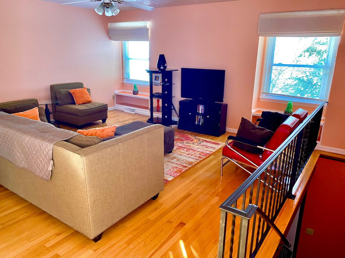 Comfortable living room with hardwood floors and large windows