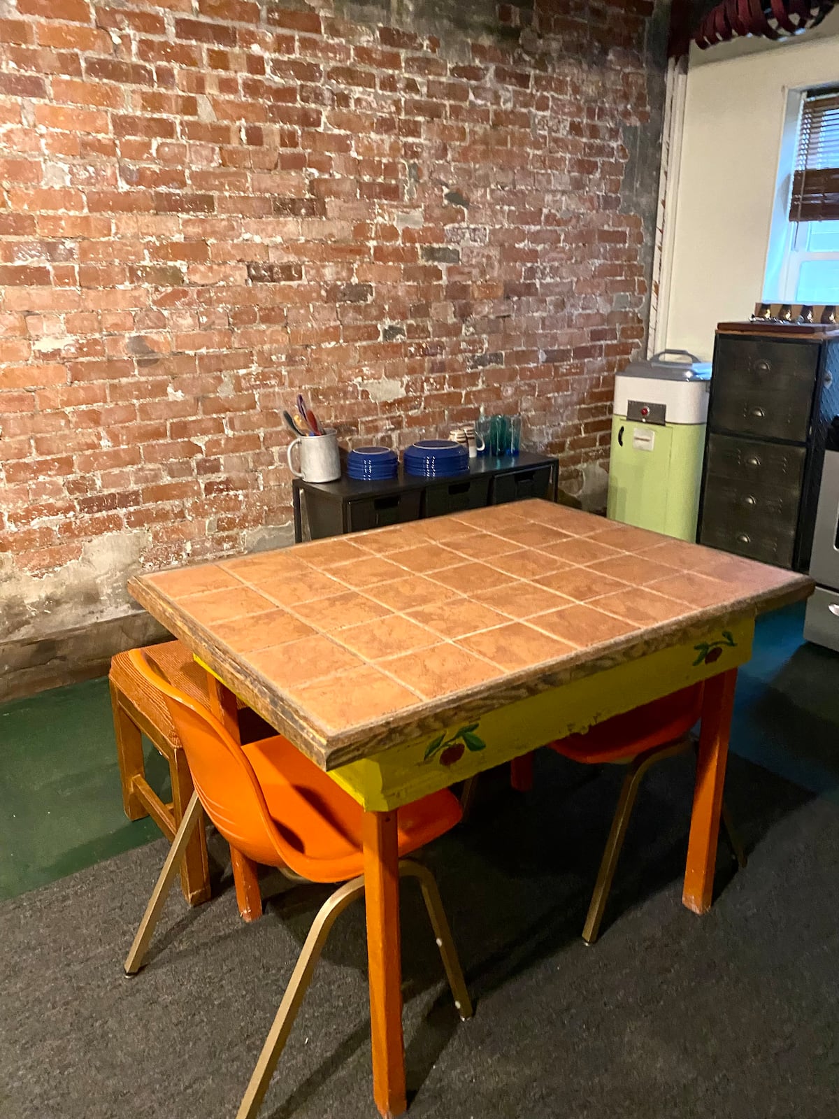 Dining table beside the exposed brick wall